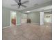 Large living room with tiled flooring, ceiling fan, and built in storage at 646 Riverside Dr, Tarpon Springs, FL 34689
