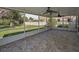 Spacious screened porch with fan and decorative tile flooring, perfect for outdoor entertaining and relaxation at 646 Riverside Dr, Tarpon Springs, FL 34689