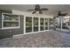 Screened-in porch with decorative tile flooring, large sliding glass doors and ceiling fans at 646 Riverside Dr, Tarpon Springs, FL 34689