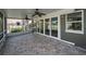 Covered and screened-in porch with decorative tile flooring, offering seamless indoor-outdoor living experience at 646 Riverside Dr, Tarpon Springs, FL 34689