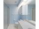 Bright bathroom with a step-in shower, blue walls and white vanity at 6741 Northlake Dr, Zephyrhills, FL 33542