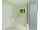 Bright bathroom featuring white tub and shower with decorative art at 6741 Northlake Dr, Zephyrhills, FL 33542