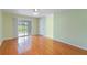 Bright bedroom with wood floors, ceiling fan, and sliding glass doors with lawn view at 6741 Northlake Dr, Zephyrhills, FL 33542
