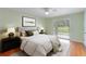 Bright bedroom with ceiling fan, sliding glass door, neutral paint, and plush carpet at 6741 Northlake Dr, Zephyrhills, FL 33542