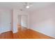 Cozy bedroom with light pink walls, wood floors, and mirrored closet at 6741 Northlake Dr, Zephyrhills, FL 33542