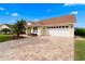 Charming one story home with a brick paver driveway and a well manicured lawn and mature landscaping at 6741 Northlake Dr, Zephyrhills, FL 33542