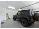 A black Jeep Wrangler parked in a brightly lit garage at 6741 Northlake Dr, Zephyrhills, FL 33542