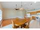 Bright eat-in kitchen with tile flooring, kitchen island, and dining area with hanging light fixture, and a ceiling fan at 6741 Northlake Dr, Zephyrhills, FL 33542