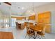Spacious eat-in kitchen with bar seating, dining table, and bright tile flooring, connected to an adjacent living space at 6741 Northlake Dr, Zephyrhills, FL 33542