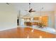 Spacious eat-in kitchen features bright tile flooring, a dining table, and an adjacent living space with hardwood floors at 6741 Northlake Dr, Zephyrhills, FL 33542