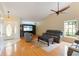 Living room featuring hardwood floors, vaulted ceilings, ceiling fan, and updated furnishings at 6741 Northlake Dr, Zephyrhills, FL 33542
