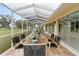 Outdoor dining area with table, chairs, and screened-in porch at 6741 Northlake Dr, Zephyrhills, FL 33542