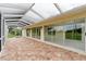 Covered brick patio featuring a screened-in enclosure at 6741 Northlake Dr, Zephyrhills, FL 33542