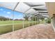 Spacious screened-in patio with brick flooring and serene backyard views at 6741 Northlake Dr, Zephyrhills, FL 33542