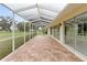 A brick patio with a screened-in enclosure provides an amazing outdoor experience at 6741 Northlake Dr, Zephyrhills, FL 33542