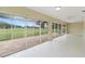 Spacious sunroom with outdoor views through sliding glass doors at 6741 Northlake Dr, Zephyrhills, FL 33542