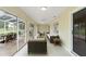 Spacious sunroom with tiled floors, sliding glass doors and comfortable seating at 6741 Northlake Dr, Zephyrhills, FL 33542