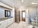 Bathroom with a shower and a white vanity with granite countertop, tiled floor, and bright lighting at 7104 Hummingbird Ln, New Port Richey, FL 34655
