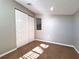 Empty bedroom showcasing carpet flooring, double door closet, neutral paint, and natural light at 7104 Hummingbird Ln, New Port Richey, FL 34655