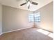 Bedroom with neutral walls, carpeted flooring, a fan, and dual windows allowing for natural light at 7104 Hummingbird Ln, New Port Richey, FL 34655