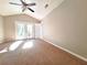 Spacious bedroom with carpet floors, ceiling fan and door to the backyard at 7104 Hummingbird Ln, New Port Richey, FL 34655