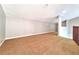 Bonus room provides versatile space with plush carpeting, ample natural light, and neutral wall colors at 7104 Hummingbird Ln, New Port Richey, FL 34655