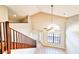 Foyer featuring an open staircase and soaring ceilings with oversized windows flooding the area with natural light at 7104 Hummingbird Ln, New Port Richey, FL 34655