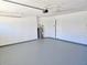 Spacious two-car garage with water heater and clean painted walls at 7104 Hummingbird Ln, New Port Richey, FL 34655