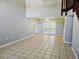 Open-concept living room with tile floors and large french doors at 7104 Hummingbird Ln, New Port Richey, FL 34655