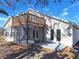 A view of the home's exterior and screened in patio with upper deck at 7104 Hummingbird Ln, New Port Richey, FL 34655