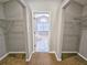 Spacious walk-in closet with wire shelving and carpeted floors. A doorway into the tiled bathroom sits between at 7104 Hummingbird Ln, New Port Richey, FL 34655