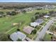 Aerial view of a residential neighborhood with homes lining a golf course with mature trees at 7292 Sherman Hills Blvd, Brooksville, FL 34602