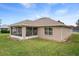 Exterior view of the home features a screened lanai and a well-maintained lawn, perfect for outdoor enjoyment at 7292 Sherman Hills Blvd, Brooksville, FL 34602