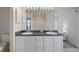 Bright bathroom featuring double sinks, white cabinets, and a large mirror at 7292 Sherman Hills Blvd, Brooksville, FL 34602