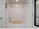 Bathroom featuring a bathtub with a shower and white walls at 7292 Sherman Hills Blvd, Brooksville, FL 34602