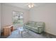 Cozy bedroom with a ceiling fan, and a large window bringing in natural light, with a comfortable couch and tv stand at 7292 Sherman Hills Blvd, Brooksville, FL 34602