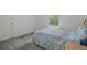 Bedroom with blue bedspread and a window view with natural light at 7292 Sherman Hills Blvd, Brooksville, FL 34602