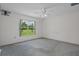 Spacious bedroom offering neutral paint, a ceiling fan, and a large window offering scenic green views at 7292 Sherman Hills Blvd, Brooksville, FL 34602