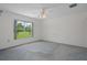 Bedroom with carpet flooring and a large window overlooking a well-maintained lawn at 7292 Sherman Hills Blvd, Brooksville, FL 34602