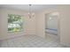 Inviting dining area with a chandelier, large window, and tiled flooring at 7292 Sherman Hills Blvd, Brooksville, FL 34602