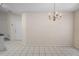 Charming dining area featuring a chandelier, tile flooring, and view through the home at 7292 Sherman Hills Blvd, Brooksville, FL 34602