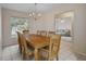 Dining room with a chandelier, window, and an adjacent living area, great for Gathering meals at 7292 Sherman Hills Blvd, Brooksville, FL 34602