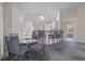 Bright dining area with a glass table set, a breakfast bar, and carpeted floors at 7292 Sherman Hills Blvd, Brooksville, FL 34602
