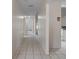 Bright hallway showcasing tiled flooring and leading to various rooms in the house, providing a sense of spaciousness and connectivity at 7292 Sherman Hills Blvd, Brooksville, FL 34602