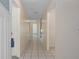 Well-lit hallway featuring tile flooring leading to various rooms in the home at 7292 Sherman Hills Blvd, Brooksville, FL 34602
