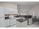 Kitchen featuring white appliances, ample cabinet space, and an island, perfect for meal preparation and entertaining at 7292 Sherman Hills Blvd, Brooksville, FL 34602