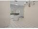 Open-concept kitchen with white cabinets, tile floors, and a view into the dining area at 7292 Sherman Hills Blvd, Brooksville, FL 34602