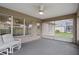 Relaxing screened lanai with comfortable seating, ceiling fan, and views of the surrounding yard at 7292 Sherman Hills Blvd, Brooksville, FL 34602