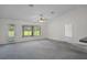 Inviting living room boasts large windows, neutral paint and open access to the kitchen and dining areas at 7292 Sherman Hills Blvd, Brooksville, FL 34602
