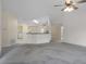 Large living area with a ceiling fan, access to other rooms, and a view of the laundry room at 7292 Sherman Hills Blvd, Brooksville, FL 34602